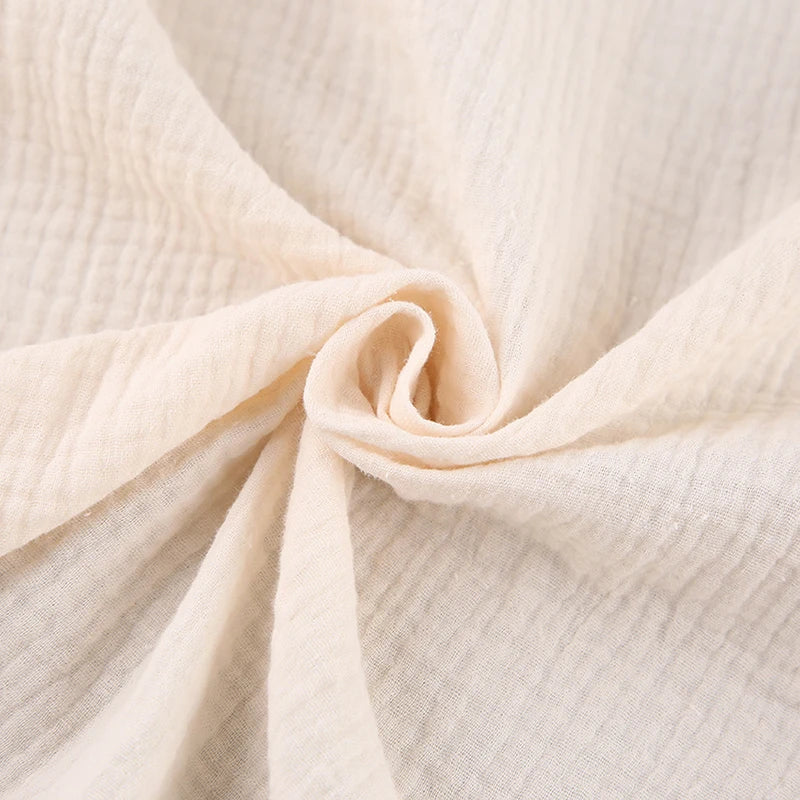 Letnia sukienka kopertowa na ramiączkach z wiązaniem w talii – muślinowa, z dekoltem V